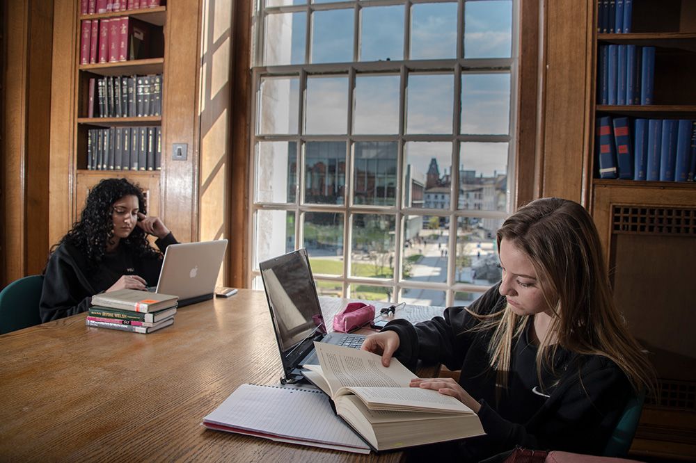 Two students in the Library reading