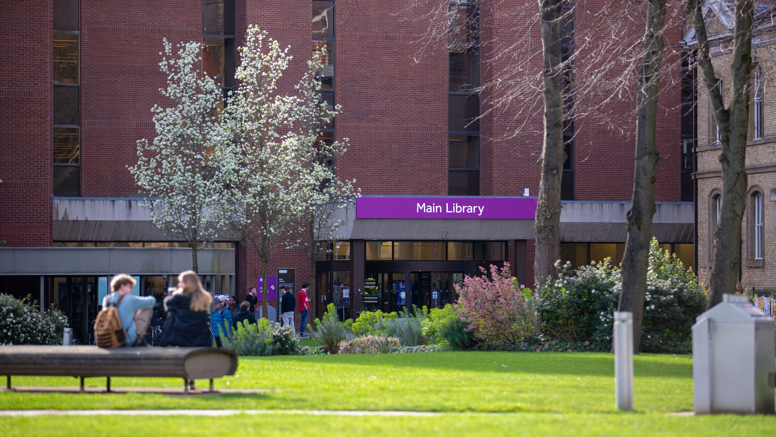 Main Library viewed from Gilbert Square with students in foreground