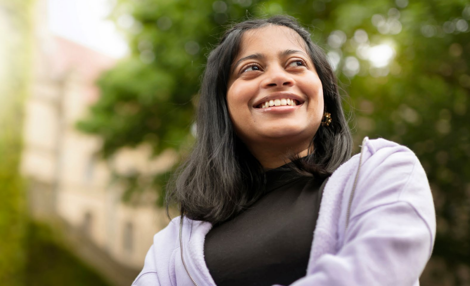 A female student looking into the distance in the University old quadrant