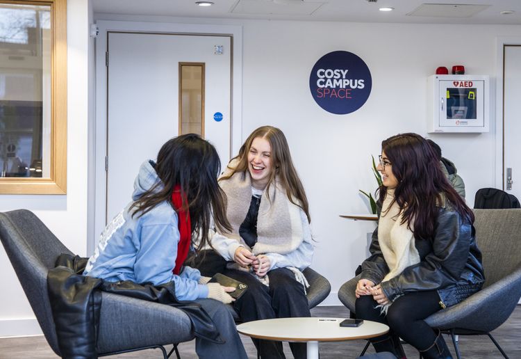 Three students laughing together in the Cosy Campus in AGLC