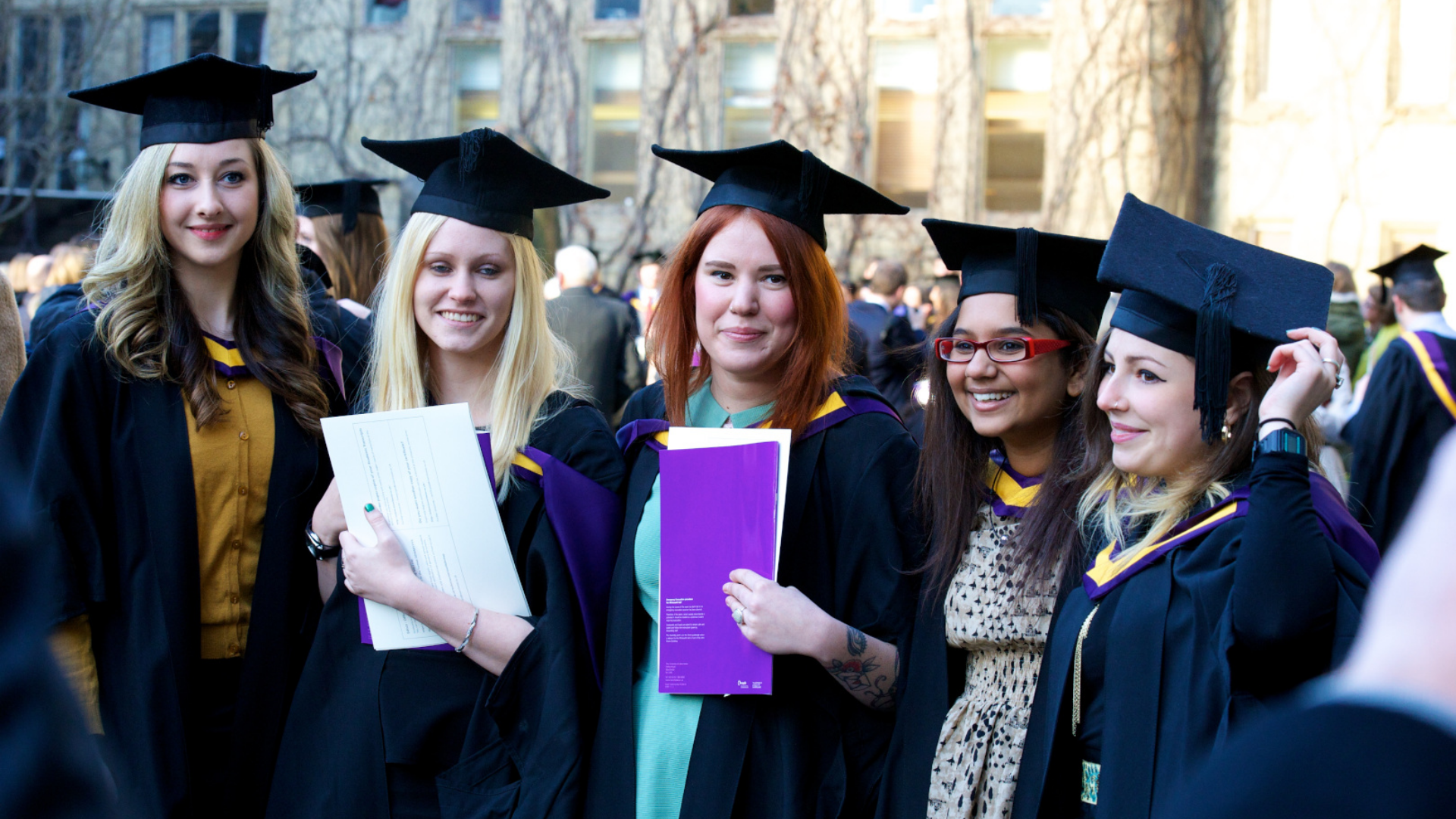 A group of students at graduation in caps and gowns