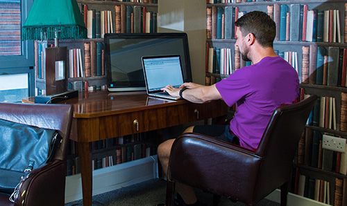 Staff member working at a computer in a home office