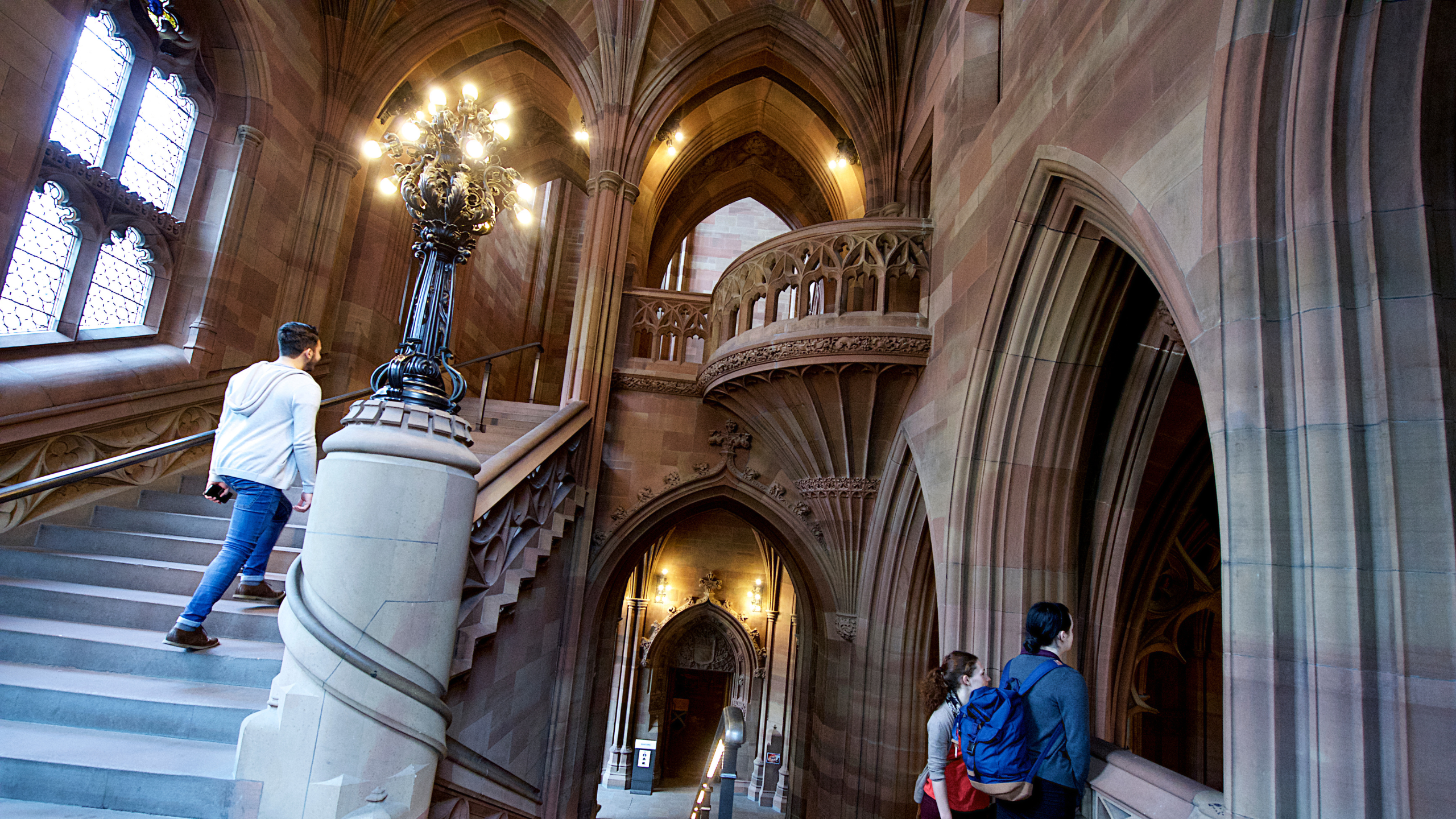 Visitors exploring the historic corridors of the John Rylands Research Institute and Library