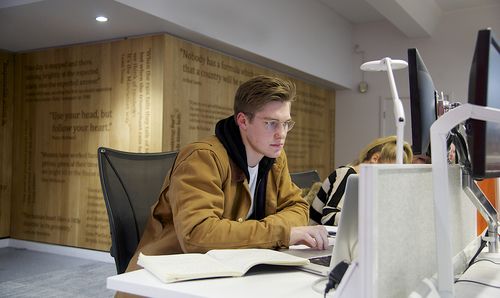 A student works at a desktop PC in one of the PC clusters in AGLC