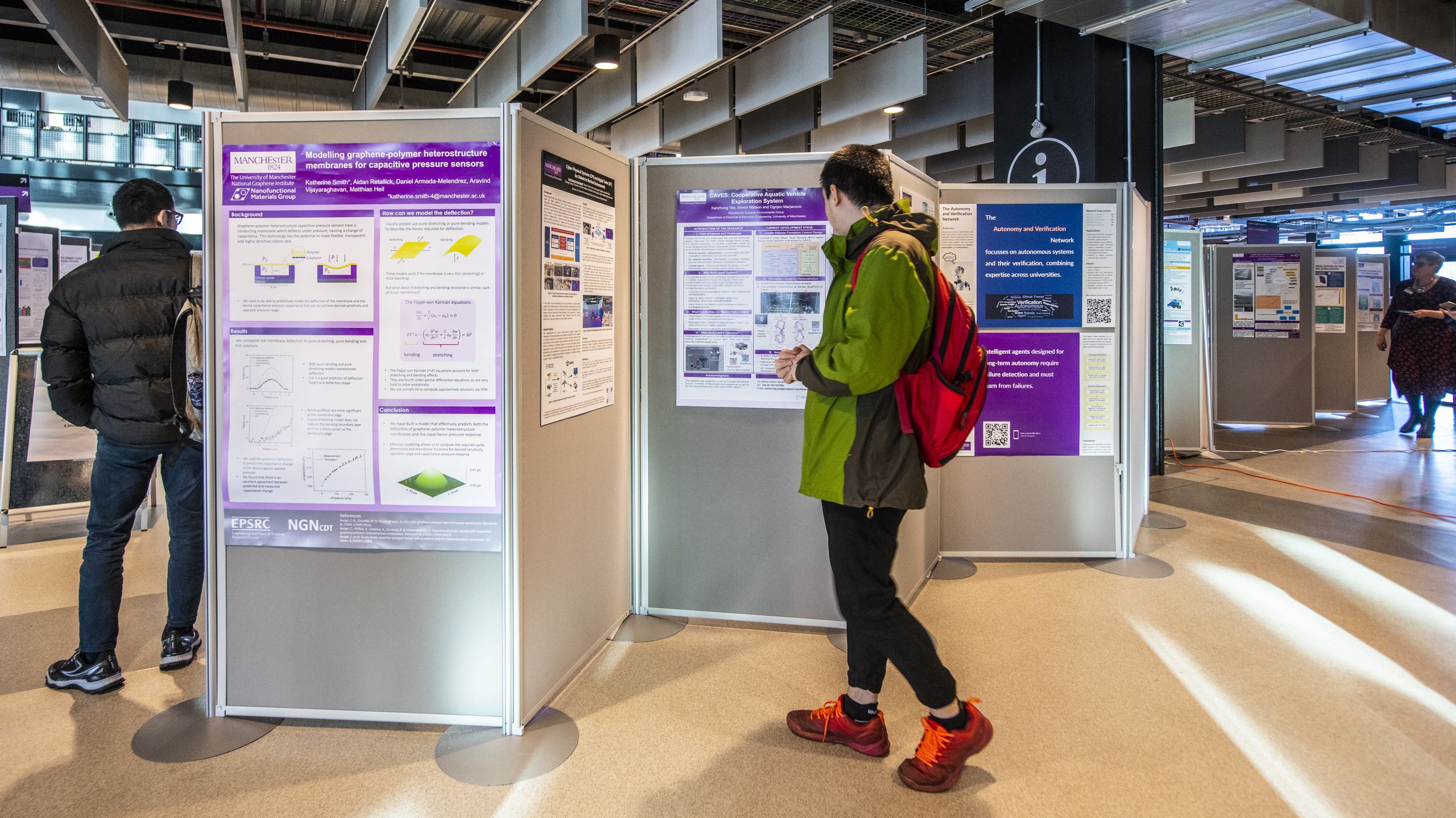 Researcher looking at a poster at an event in MECD