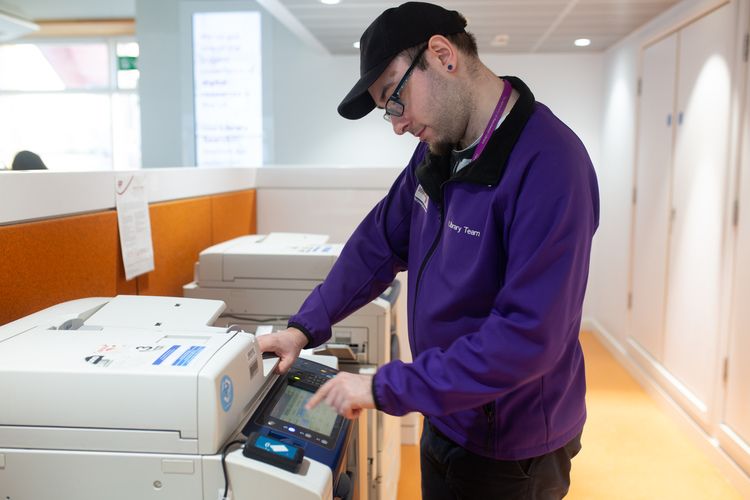 Digital Support Services staff member using printer
