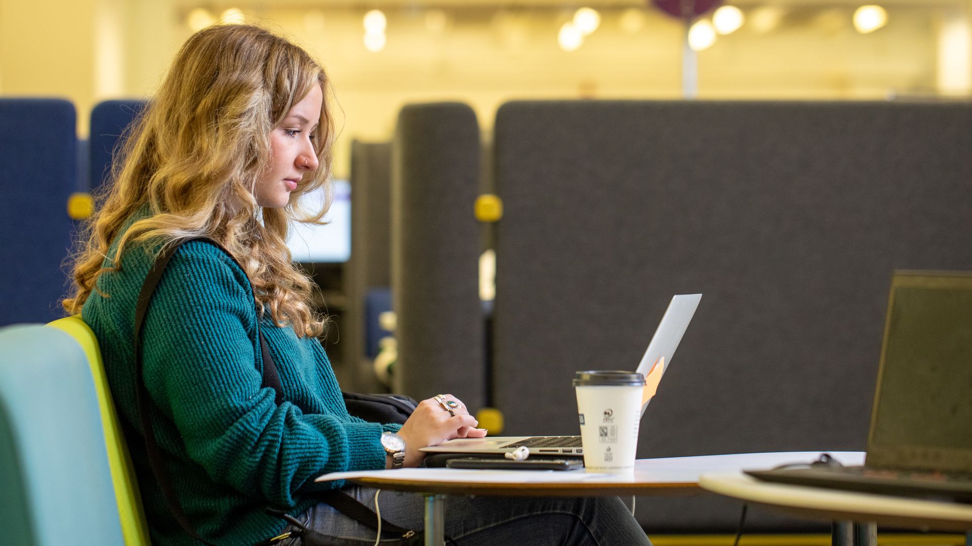 A student working on a laptop in Blue Ground