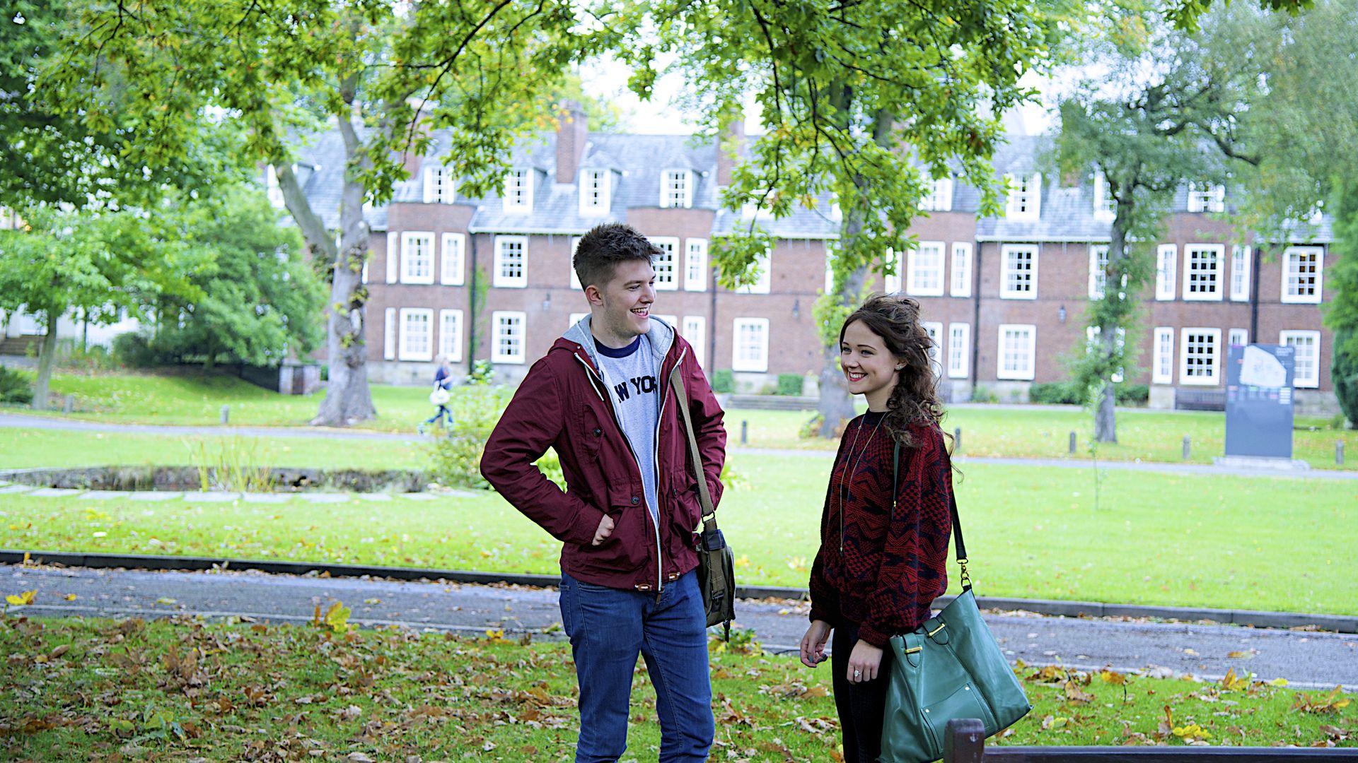 Two students outside smiling