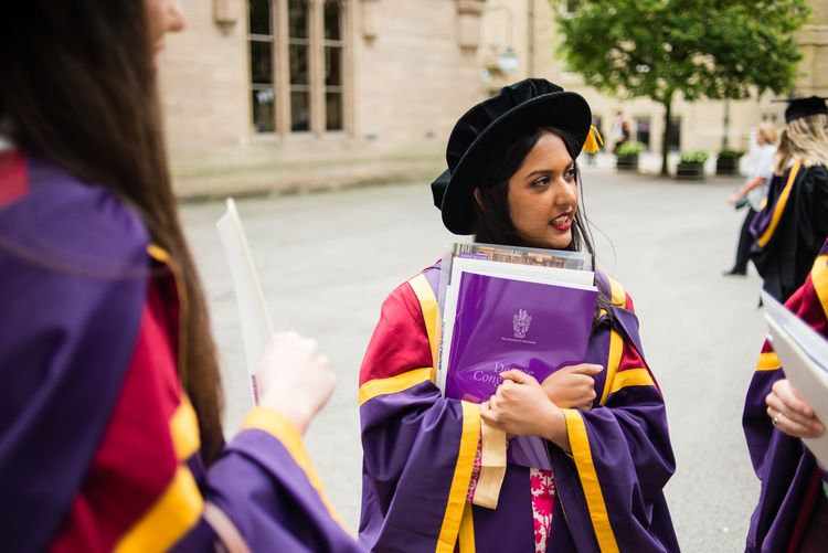 Postgraduate researcher at University of Manchester graduation ceremony in the Old Quad