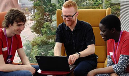 A member of Library staff talking to members of the Student Team in AGLC