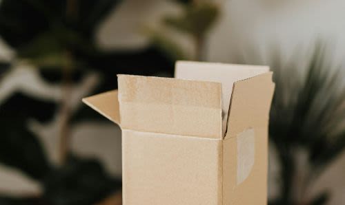 An opened cardboard box on a desk