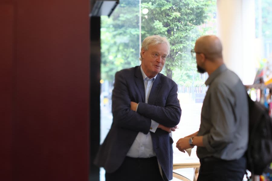 A member of Library staff speaking to the keynote speaker outside of a session
