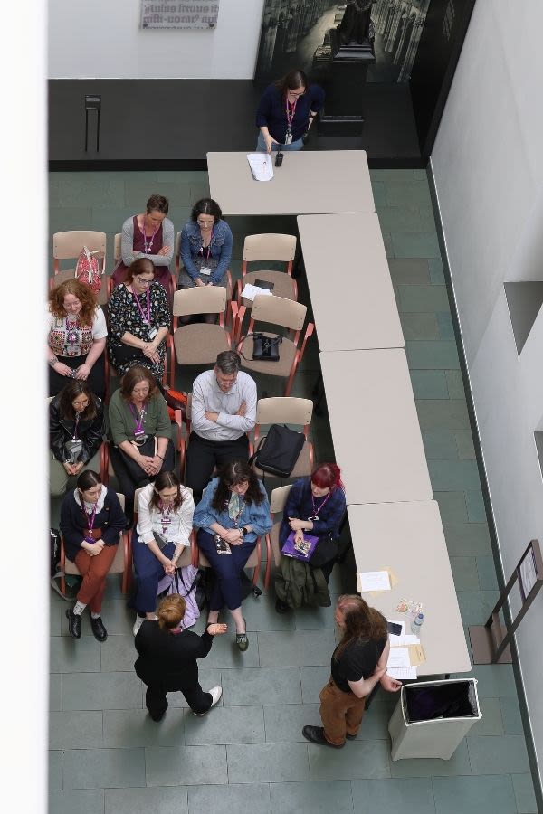 Staff as seen from above sat listening to a talk in a breakout session