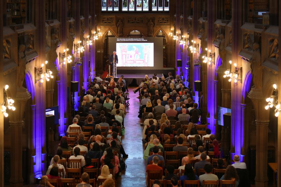 Staff watching the keynote speaker in the reading room at Rylands
