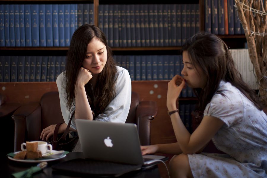 Two students looking at a laptop together
