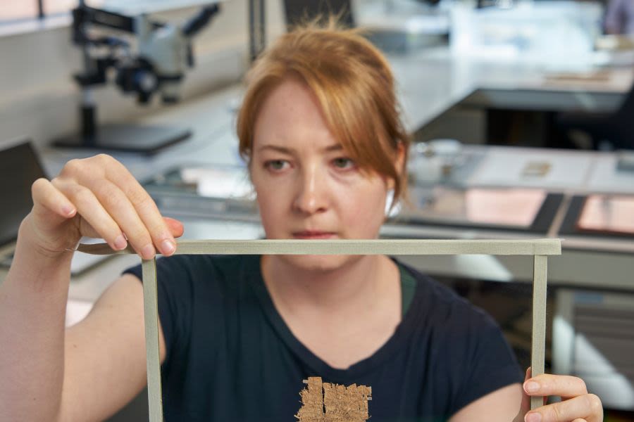 Member of collection care staff examining an item