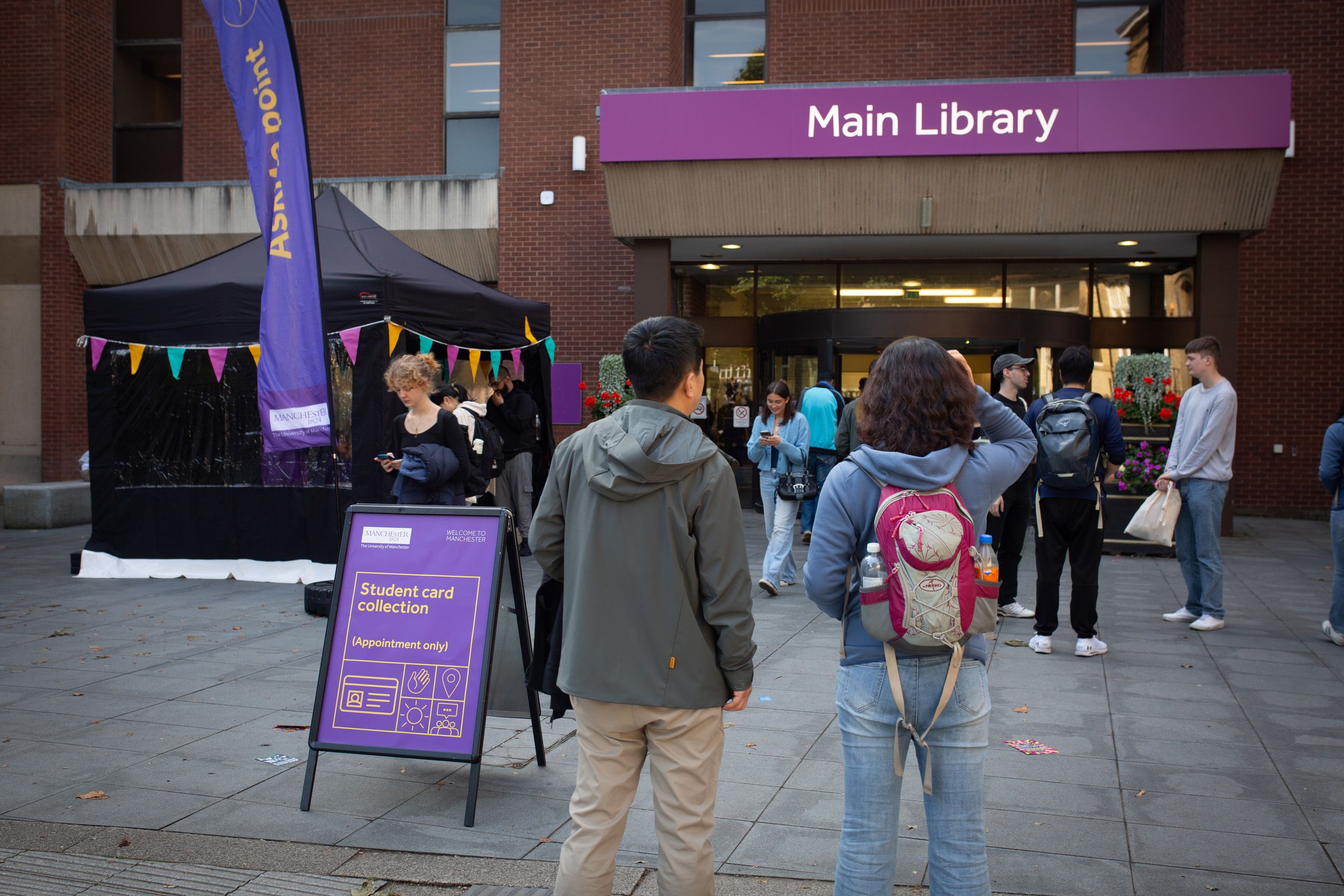 Two students looking at Main Library during Welcome Week