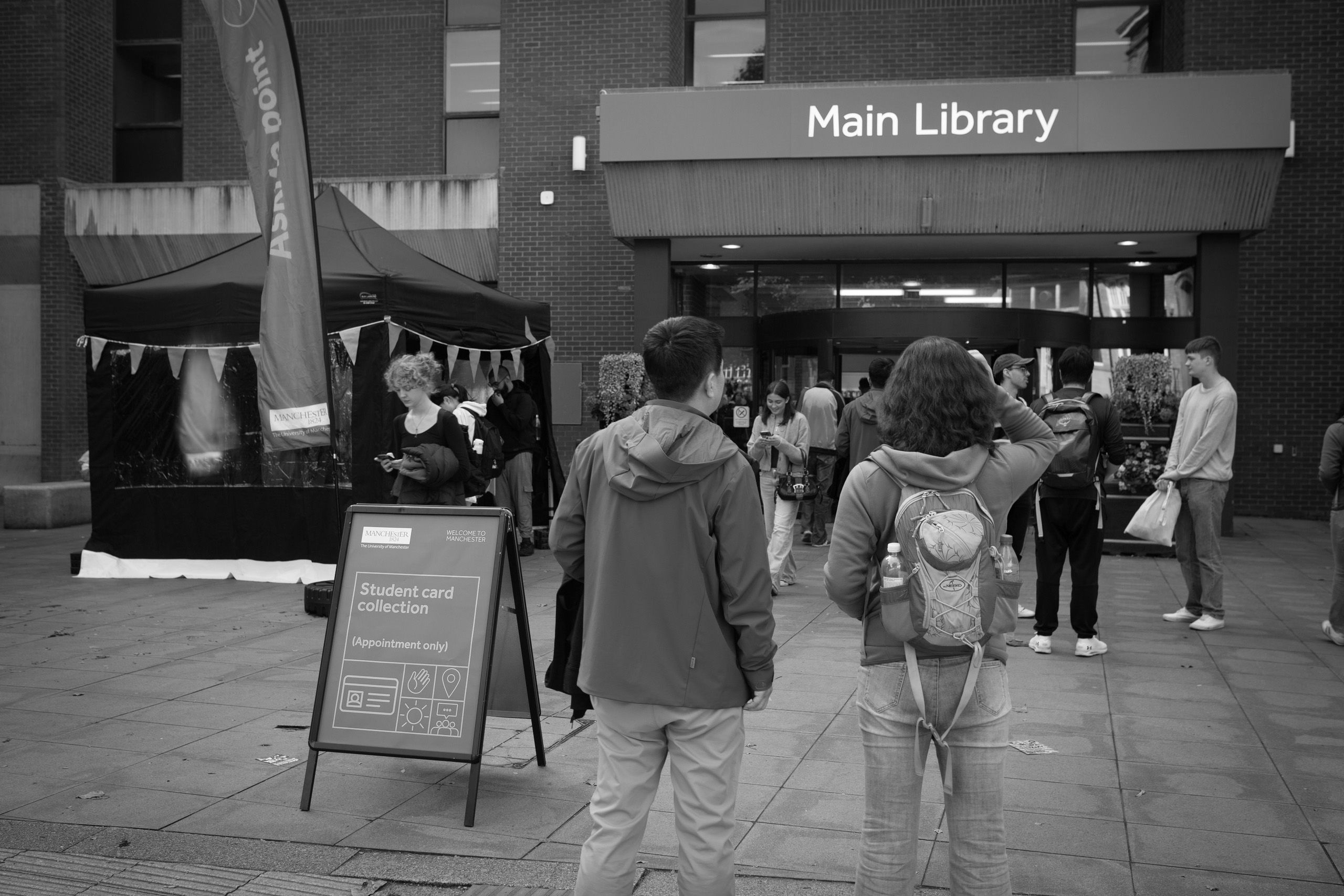 Two students looking at Main Library during Welcome Week