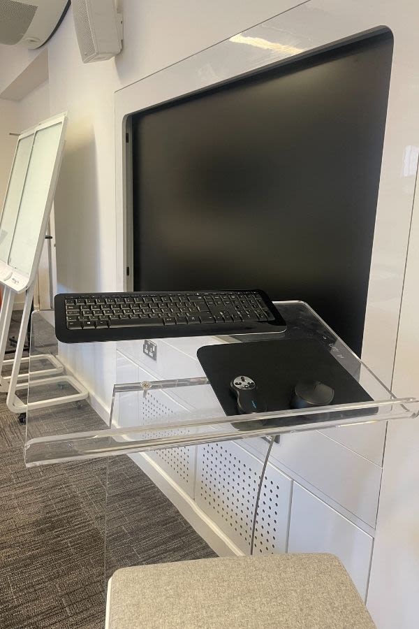 A large screen with a keyboard placed nearby